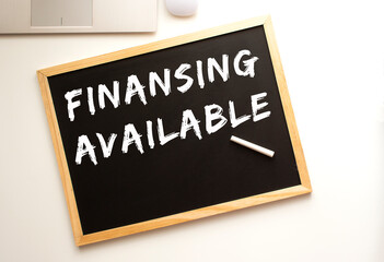 The text is written in chalk on a slate board. business concept