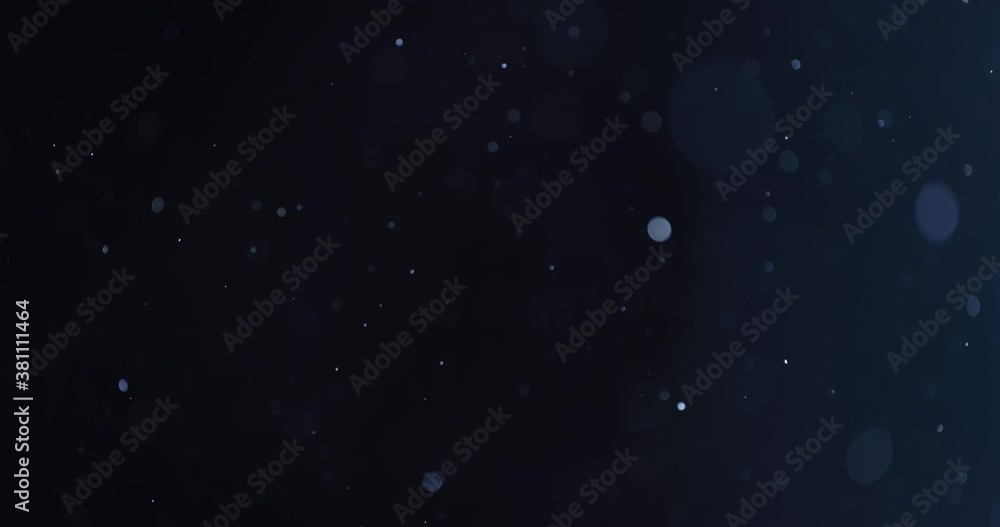 Wall mural floating abstract particle bokeh on dark background