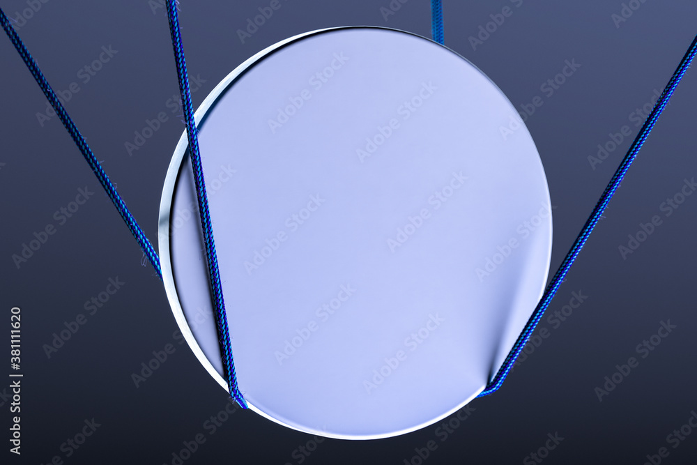 Poster blank round signboard mockup tied with ropes. empty signage template on dark background and illumina