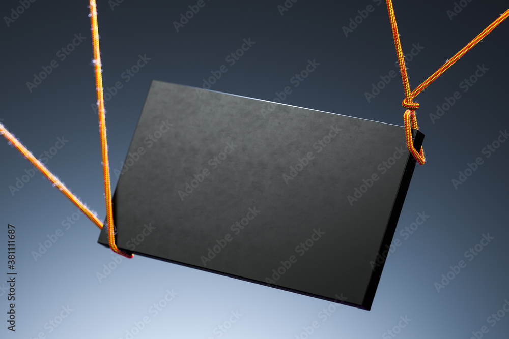 Poster blank black foursquare signage template on dark background illuminated by light. 3d rendering