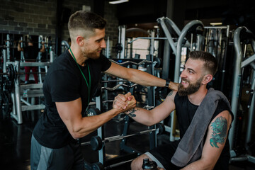 Support from personal trainer in gym