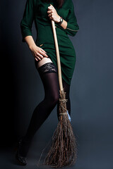 witch in green dress  with broom