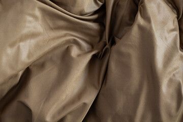 Draped shiny copper satin fabric texture
