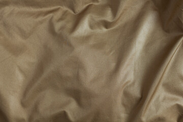 Golden silk fabric texture. Drapery