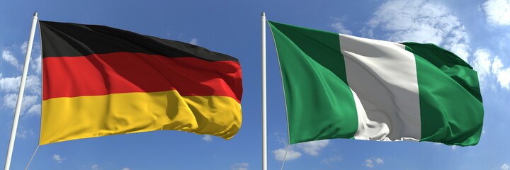 Flying flags of Germany and Nigeria on sky background, 3d rendering