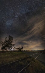 Countryside railway cross under sky full of stars