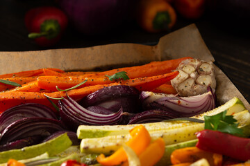 Stewed vegetables on a baking sheet, carrots with garlic and red onions,zucchini with bell pepper and beetroot, sweet and hot peppers and spices