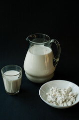 Different dairy products on the white wooden boards, blurred background