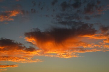 Beautiful orange flame shape clouds in the sky at sunset, natural background
