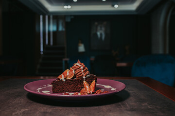 Closeup shot of a piece of chocolate cake with pecan and fig