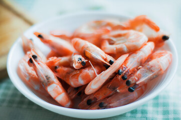 full plate of shrimp, blurred background
