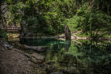 Mountain brook with wooden bridge