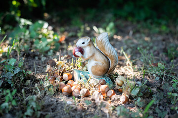 Squirrel eating nut in the forest on the ground - vintage ceramic figurine