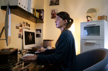 
pensive girl drinking coffee at home and teleworking