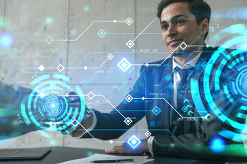 Two businessman shaking hands and technology theme hologram. Double exposure. Concept of partnership.