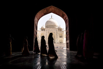 Women in traditional saris passing by Taj Mahal in Agra, Uttar Pradesh, India
