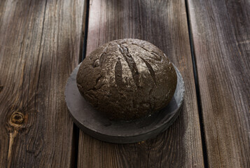 homemade rye bread with cuttlefish extract, fresh baked aromatic on an old wooden table