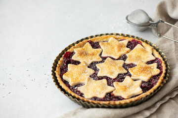 homemade raspberry pie made from crumbly dough on a white table