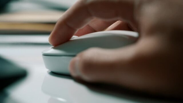 White computer mouse on a work desk. Working with a PC and click on the mouse. Footage of the workplace in 4K