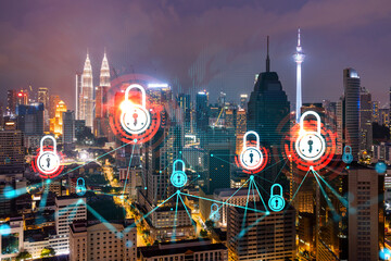 Glowing Padlock hologram, night panoramic city view of Kuala Lumpur, Malaysia, Asia. The concept of cyber security to protect KL companies. Double exposure.