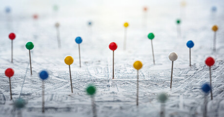 Multi-colored pins on the city map as a search symbol. Find your way among the many. Concept on the topic of geography, navigation, transport. Shallow depth of focus. Pins on map.
