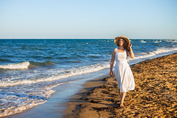 Fototapeta na wymiar happy woman walking on sea beach