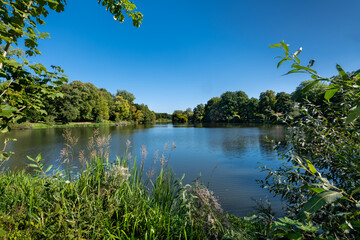 Reinbek, Germany, near Hamburg. The lake Muehlenteich at the Reinbek Castle (German: Schloss Reinbek). Built in the 16th century in Dutch Renaissance style, it is beautifully restored.