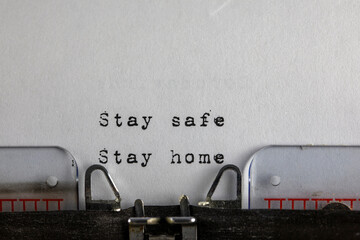 written on old typewriter with text Stay safe stay home. Covid-19, Coronavirus concept