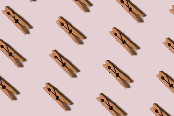 Pattern. Many wooden clothespins on a light background. The concept of household items.