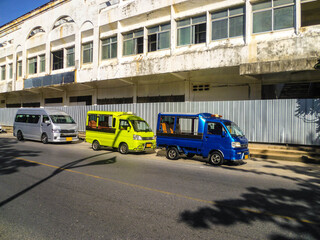 Fototapeta na wymiar Colorful minibuses await tourists for city tours in Phuket.