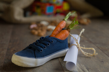 Fototapeta premium A kid places his shoe with carrots for Amerigo, the horse of Sinterklaas and a drawing for Sinterklaas, Then he dreams of a bag full of presents and candy.