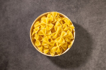 italian pasta, farfalle. Concrete background