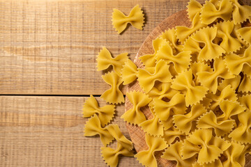 italian pasta, wood background, farfalle