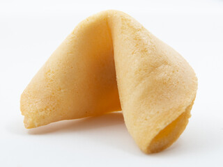 Close-up of unopened fortune cookie on white background