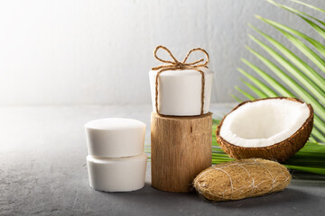 Handmade coconut oil soap white color with palm leaf on grey concrete background.