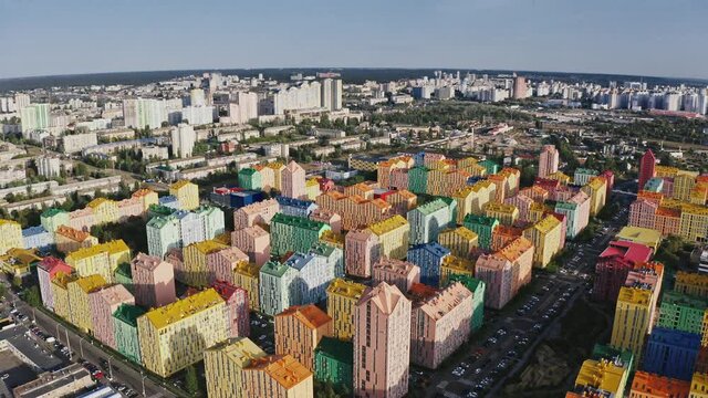 Tracking shot from drone height of multicolored buildings in residential urban district