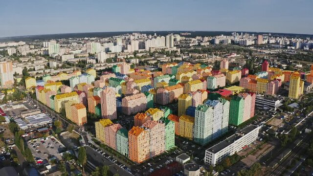 Drone flight over colorful residential district, tracking shot of design architecture in big city