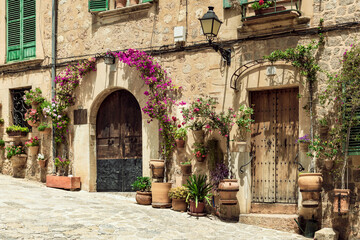 Typical alley in the mountain village of Valldemossa with potted plants at the facades
