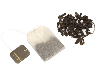 Black tea bag and black tea heap on a white background
