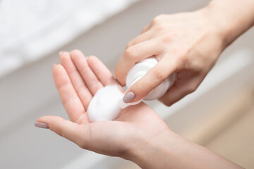 Beauty and face care, women's hands with foam for washing