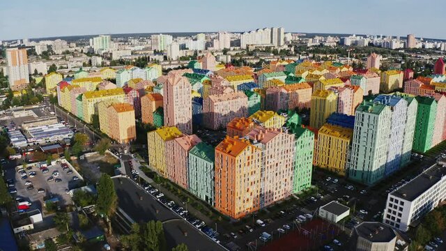 Drone flight footage of modern colorful residential area in big city, aerial view