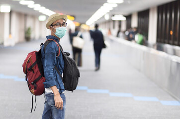 Tourist man with wearing face mask at terminal in airport, Travel new normal concept