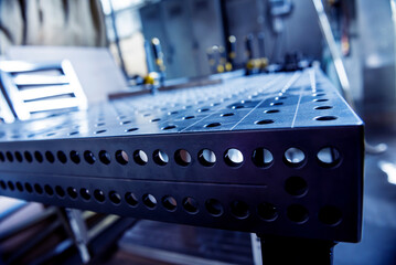 Metal welding table with mounting brackets at metal manufactory
