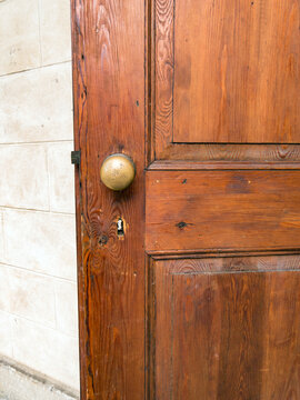 An Old Wooden Door With A Round Metal Door Knob