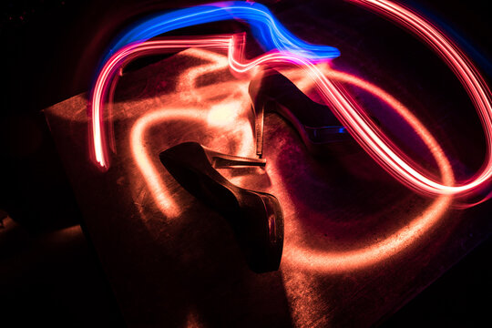 Silhouette of a high heel women shoes at dark. Women power or women domination concept.