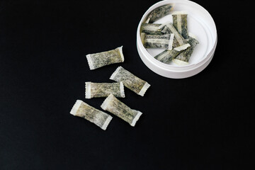 Round box with snus. Cigarette substitute, nicotine pouches.