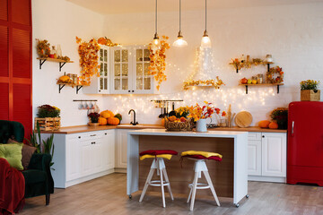 Autumn kitchen interior. Red and yellow leaves and flowers in the vase and pumpkin on light background - 381144034