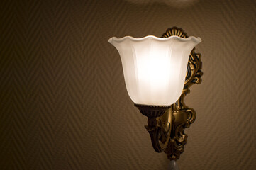 Blur. Old vintage lamp on the wall in frosted glass and muted light. Background