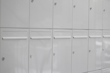 white mailboxes on the wall of an apartment building