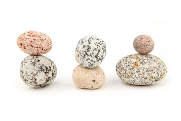 Sea smooth oval pebbles isolated on white background. Stacked round pebbles stones.